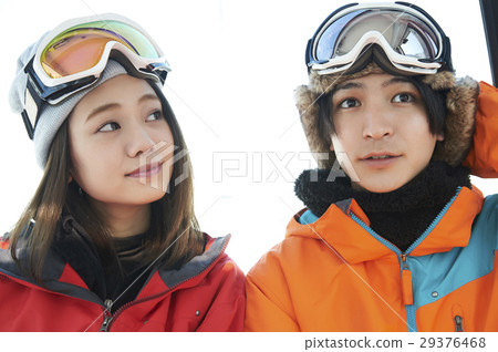 A couple riding a ski resort gondola 29376468