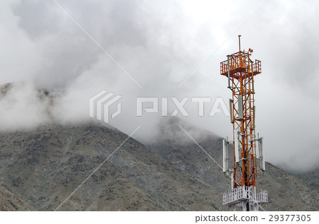 Communication tower with snow mountain and fog 29377305