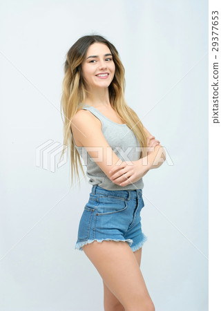 Young girl with long curly hair posing on blue 29377653