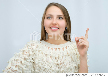 Young girl with long curly hair posing on blue Young girl with long curly hair posing on blue 29377657