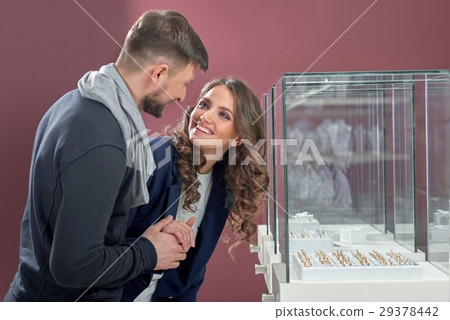 Young couple in love buying rings at the jewelry Young couple in love buying rings at the jewelry 29378442