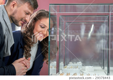 Young couple in love buying rings at the jewelry Young couple in love buying rings at the jewelry 29378443
