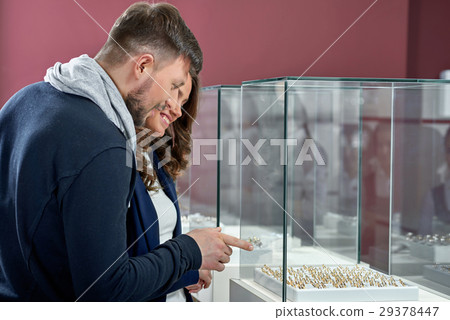 Young couple in love buying rings at the jewelry Young couple in love buying rings at the jewelry 29378447