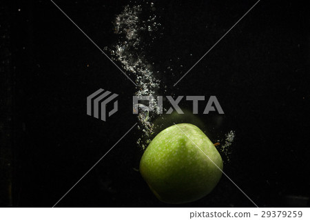 Organic green apple falls in water before Organic green apple falls in water before 29379259