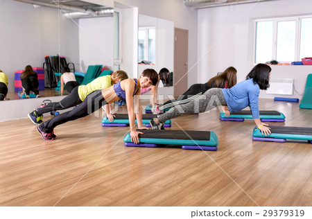 fitness group of smiling women training in gym 29379319