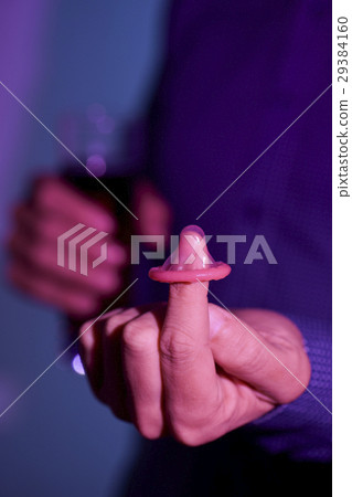 young man with condom and mixed drink 29384160