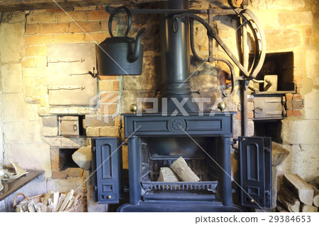 Old style iron, wood burning fireplace with kettle Old style iron, wood burning fireplace with kettle 29384653