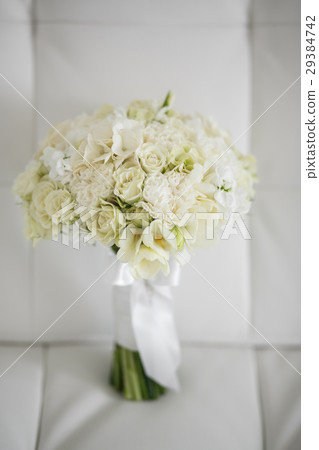Wedding bouquet made of white roses on a white Wedding bouquet made of white roses on a white 29384742