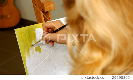 Female artist draws a pencil sketch in art studio Female artist draws a pencil sketch in art studio 29390803