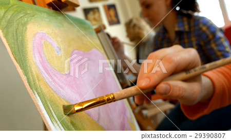 Female artist draws a pencil sketch in art studio Female artist draws a pencil sketch in art studio 29390807