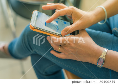 Woman holding smartphone with google map. 29400215