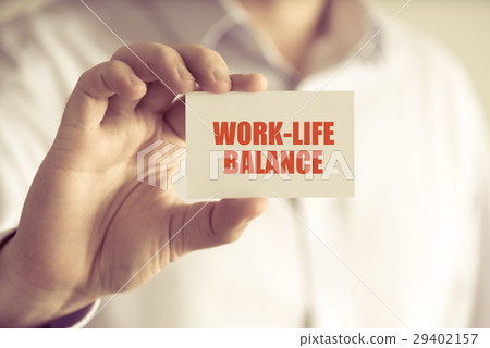 Businessman holding WORK-LIFE BALANCE message card Businessman holding WORK-LIFE BALANCE message card 29402157