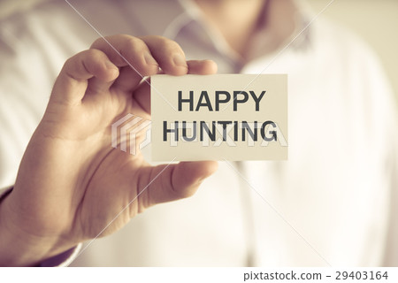 Businessman holding HAPPY HUNTING message card Businessman holding HAPPY HUNTING message card 29403164