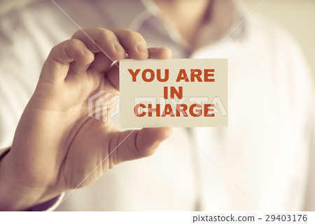 Businessman holding YOU ARE IN CHARGE message card Businessman holding YOU ARE IN CHARGE message card 29403176