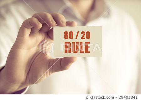 Businessman holding 80 20 RULE message card 29403841