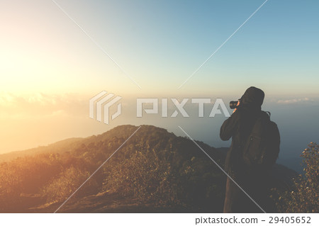 silhouette man shoot photo on peak of mountain  29405652