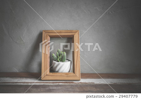 photo frame with cactus flower on wood table photo frame with cactus flower on wood table 29407779