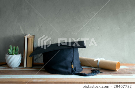 graduation cap, hat with degree paper on wood  29407782