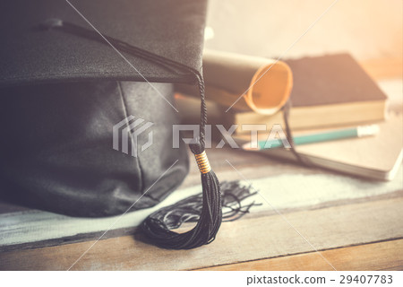 graduation cap, hat with degree paper on wood  29407783