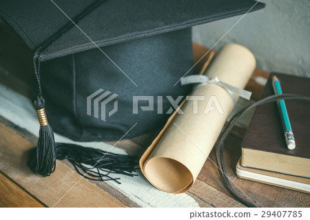graduation cap, hat with degree paper on wood 29407785