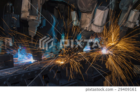 Robots welding metal in factory Robots welding metal in factory 29409161