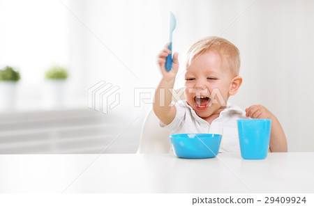 Happy baby eating himself 29409924