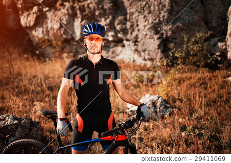 Portrait of a cyclist in helmet and sunglasses on 29411069