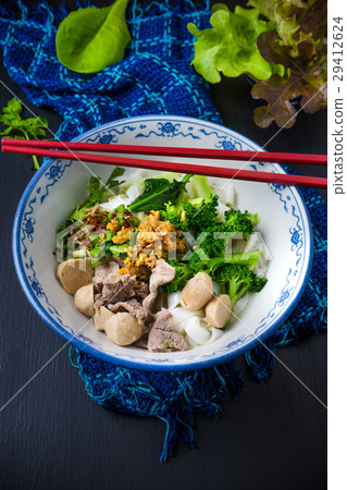 Bowl of asian noodles with vegetables and pak 29412624