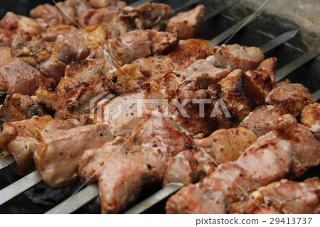 Meat porkis fried on the grill skewers at coals Meat porkis fried on the grill skewers at coals 29413737