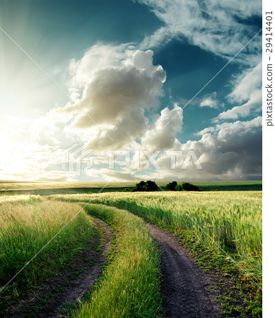 road in green field and sunset in clouds road in green field and sunset in clouds 29414401