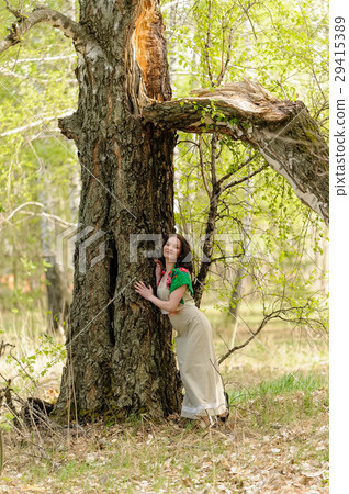 Beautiful woman stands near birch 29415389