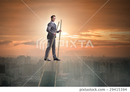 Businessman walking on stilts - standing out from 29415394