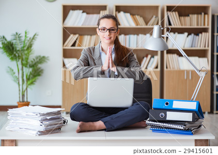 Businesswoman meditating in the office 29415601