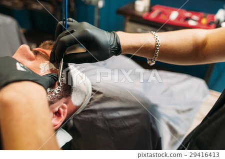 Shaving man at barbershop closeup free space Shaving man at barbershop closeup free space 29416413