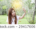 woman holding her mobile phone and taking selfie 29417606