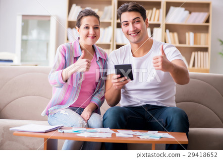 Young family discussing family finances Young family discussing family finances 29418652