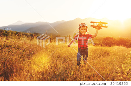 Child pilot aviator with airplane dreams of traveling in summer Child pilot aviator with airplane dreams of traveling in summer 29419263