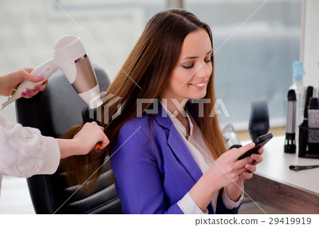Woman getting her hair done in beauty shop Woman getting her hair done in beauty shop 29419919