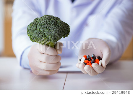 Doctor offering choice between healthy and Doctor offering choice between healthy and 29419948