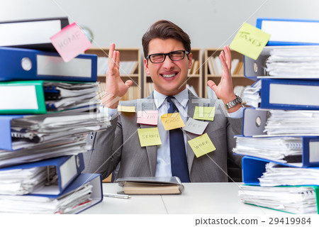 Businessman struggling with multiple priorities Businessman struggling with multiple priorities 29419984