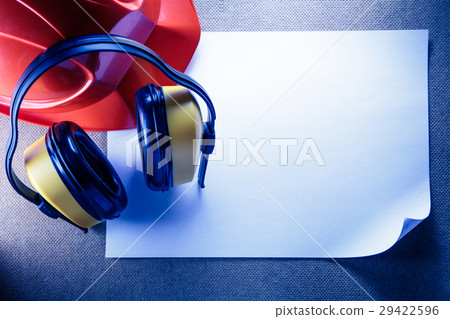 Helmet, earphones and blank sheet of paper 29422596