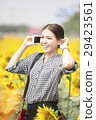 woman smiling while using mobile phone 29423561