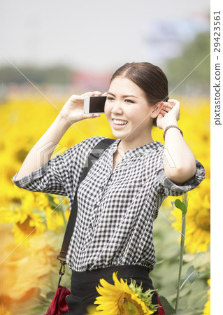 woman smiling while using mobile phone 29423561