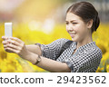 woman smiling while   selfie  29423562