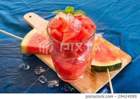 Piece of water melon on Chopping board. 29424099