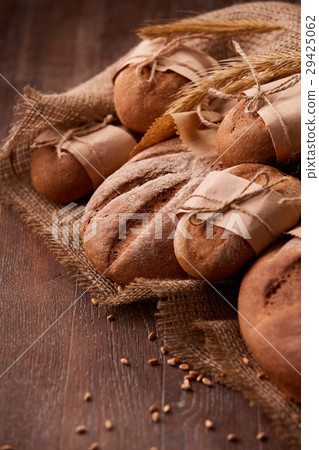 Fresh rye bread on the wooden table, wheat, paper 29425062