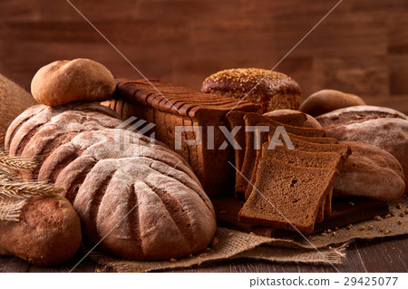 Different kinds of bread on burlap on the wooden 29425077