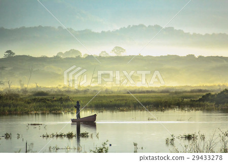Fisherman is on fishing boat in the morning 29433278