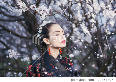 Asian woman meditating in garden Asian woman meditating in garden 29434297