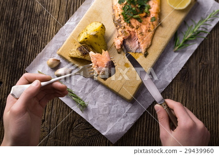 Trout with potateos on wooden board. Trout with potateos on wooden board. 29439960